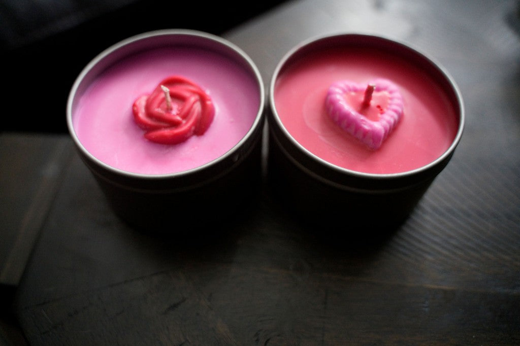 Two tin candles topped with a rose and a heart